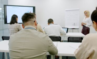 Participants at a professional training session in a modern seminar room