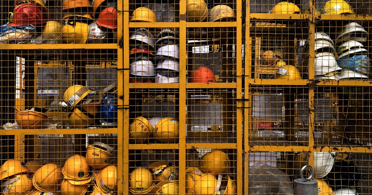 Rack of yellow safety hard hats in an industrial storage area