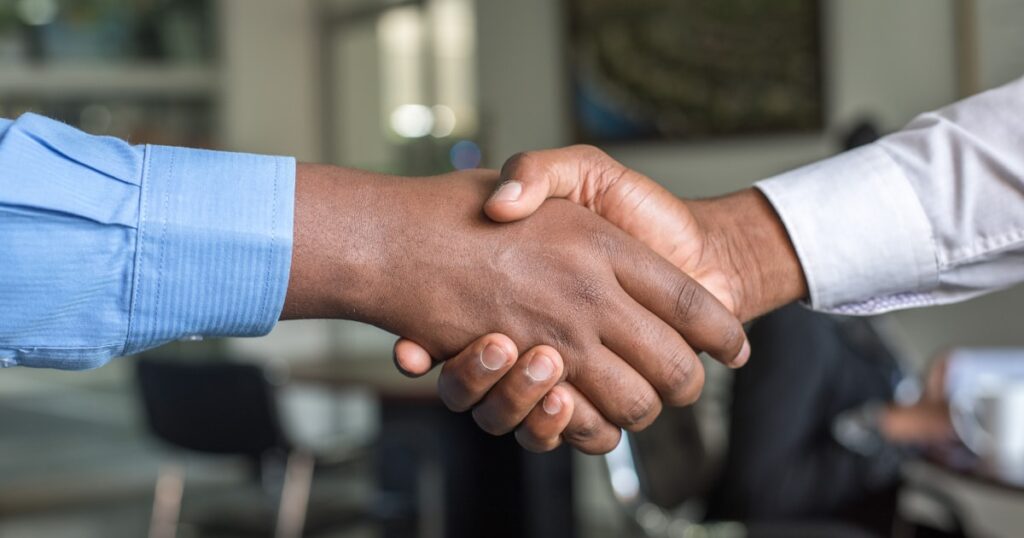 Two professionals shaking hands after a successful interview